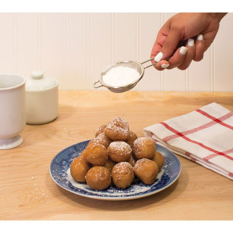 Kitchen Mesh Strainer 30010
with powdered sugar being sprinkled over donuts
