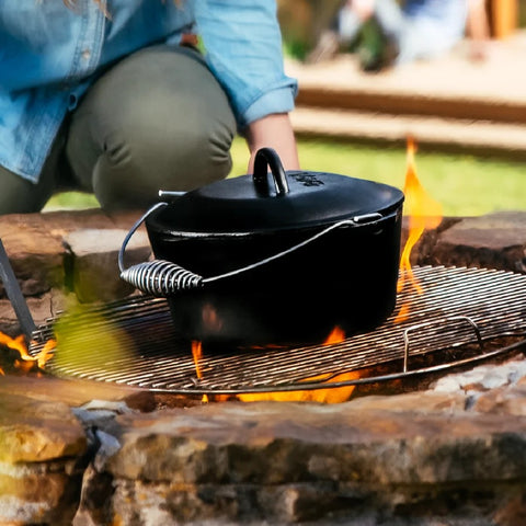Lodge Cast Iron Dutch Oven with Bail Handle over campfire grill