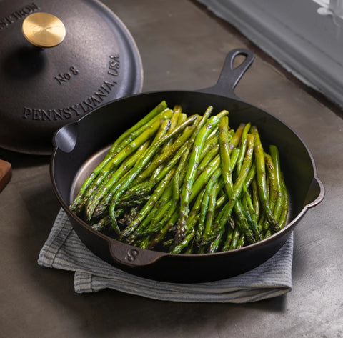 Asparagus cooking in cast iron skillet